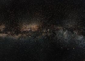 Night sky, many stars with milky way around Cepheus and Cygnus constellation, Andromeda galaxy visible in lower left corner. Long exposure stacked photo