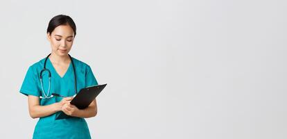 Healthcare workers, preventing virus, quarantine campaign concept. Serious-looking professional female doctor, nurse in scrubs writing down info on clipboard, examine patient, white background photo