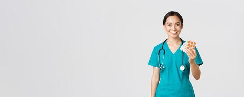 Healthcare workers, preventing virus, quarantine campaign concept. Friendly-looking female asian nurse, doctor explain patient medication prescription, showing drugs and smiling, white background photo