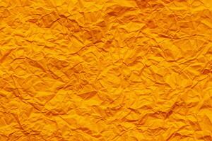 Orange crumpled paper background photo