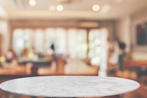 round marble table top with cafe restaurant bokeh lights abstract background for montage product display photo