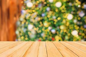 Empty wood table top with Abstract blur Christmas tree with decoration bokeh light background for product display photo