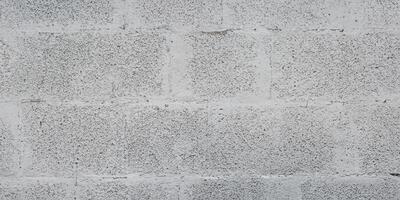 Grey brick cinder block wall background concrete tile cladding seamless texture photo