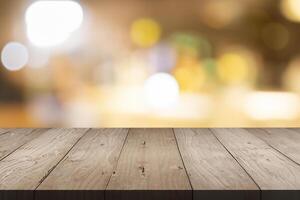 Empty brown wood table top on blur background at shopping mall, copy space for montage you product photo