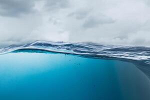 The deep blue sea at the time of the storm can be seen from under the water. Abstract wave blur under water photo