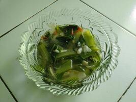 Vegetable Soup in clear bowl. Traditional hot veggie soup and delicious. photo