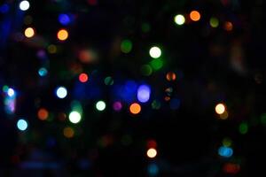 Colorful multicolored defocused bokeh lights on a blurred night background photo