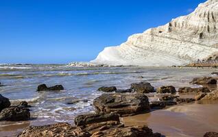 View of the limestone white cliffs with the beach at Stair of the Turks or Turkish Steps near Realmonte in Agrigento province. Sicily, Italy photo