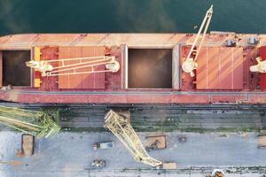 Top view from a drone of a large ship loading grain for export. Water transport photo