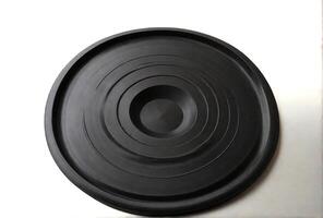 AI generated Black Frisbee on wooden background photo