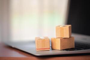Stack of cardboard boxes on a laptop keyboard photo