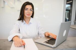 Young female receptionist working in office photo