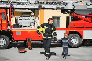 Protect people from dangerous with brave heart.Hero in fireman with uniform safe children from burn smoke photo