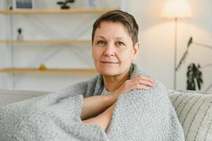 Portrait of a beautiful senior woman smiling at home. Old granny. photo