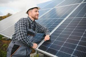 Men technicians installing photovoltaic solar moduls. Concept of alternative and renewable energy. photo