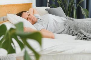 middle-aged woman sleeping in bed at home. photo