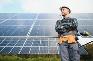 Professional worker installing solar panels on the metal construction, using different equipment, wearing helmet. Innovative solution for energy solving. Use renewable resources. Green energy. photo