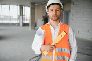 Close up engineers working on a building site holding a blueprints.Engineering and architecture concept photo