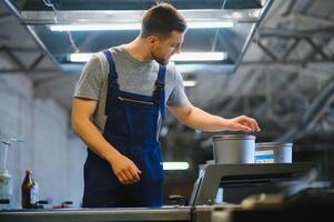 Printing house. The printer works in a modern production hall. photo