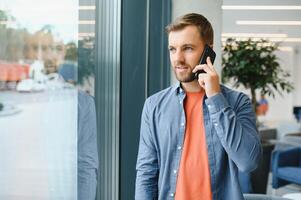 Portrait of attractive cheerful man leader partner using device app developing web it project at work place station indoors photo