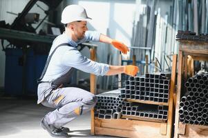 Factory worker measures the metal profile photo