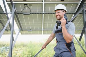 Worker installing solar panels outdoors photo