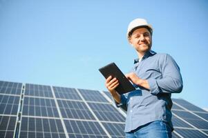 Solar power plant. Engineer on a background of photovoltaic panels. Science solar energy. photo