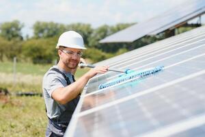 young worker cleaning solar panels. photo