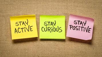 stay active, curious and positive - the keys to healthy aging, inspirational reminder on sticky notes photo