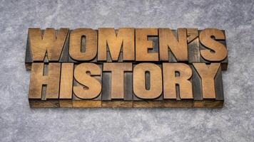 women's history - word abstract in vintage letterpress wood type, contributions of women to events in history and contemporary society photo