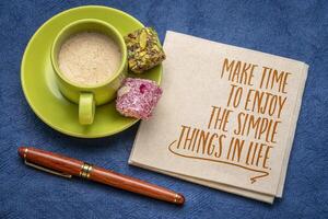 Make time to enjoy the simple things in life - inspirational note on a napkin with cup of coffee, self care and personal development concept photo