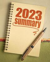 2023 year summary text in a spiral notebook, end of year business concept photo
