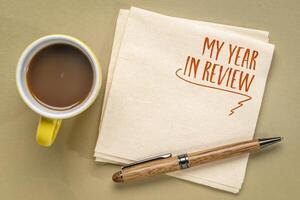 my year in review - a note on a napkin with coffee, end of year personal exeperience and story concept photo