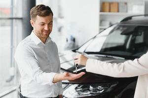 Man buying a car at a showroom photo