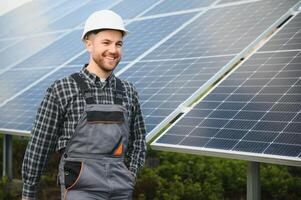 Professional worker installing solar panels on the metal construction, using different equipment, wearing helmet. Innovative solution for energy solving. Use renewable resources. Green energy. photo