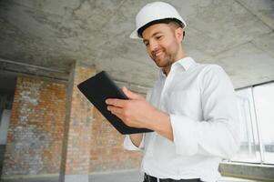 Close up engineers working on a building site holding a blueprints.Engineering and architecture concept photo