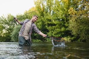 trout being caught in fishing net. photo