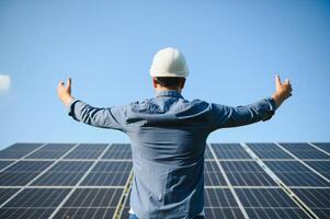 Solar power plant. Engineer on a background of photovoltaic panels. Science solar energy. photo