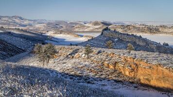 winter scenery in foothills of Rocky Mountains in northern Colorado with frozen Horsetooth Reservoir photo