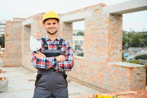 Construction worker in uniform and safety equipment have job on building photo