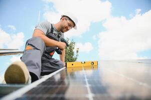 Solar panel. Technician installing solar panels on a sunny day photo