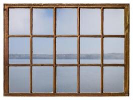 foggy morning over a lake or wide river as seen from a retro sash window photo