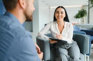 Depression Counseling. Desperate Man Telling About Unhappy Life While Professional Psychologist Taking Notes During Appointment In Office. Selective Focus photo