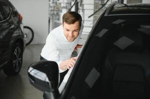 Man buying a car at a showroom photo