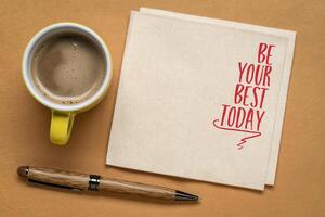 Be your best today - inspirational note on a napkin with coffee, mindset and personal development concept photo