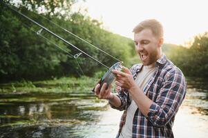 Male hobby. Ready for fishing. Relax in natural environment. Trout bait. Bearded elegant man. Man relaxing nature background. Strategy. Hobby sport activity. Activity and hobby. Catching and fishing photo