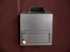 silver charity box in the mosque with a small lock photo