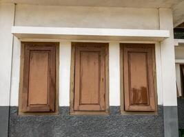 three windows without glass were painted brown and were slightly damaged photo