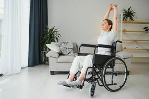 Brunette woman working out on wheelchair at home photo