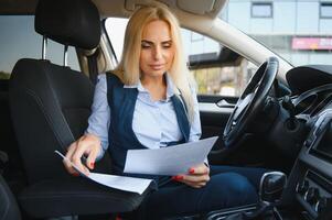 Portrait of business elegant middle-aged woman in car. photo